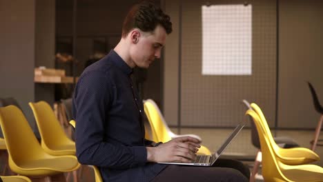 Young-Attractive-Male-Typing-Something-On-A-Laptop