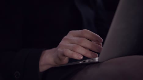 Attractive-Male-In-Stylish-Trench-Coat-Typing-Something-On-Laptop-Keyboard-While-Sitting-And-Riding-In-A-Car