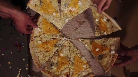 Top-View-Of-Hands-Adults-Taking-Pizza-Slices-From-Cardboard-Box