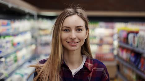 Portrait-Woman-Stands-In-Front-Of-The-Camera-And-Smiles-In-Supermarket