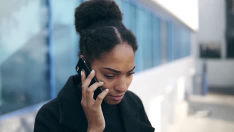 Close-Up-Portrait-Of-Black-Woman-Talking-On-Mobile-Phone-Solving-Business-Issues-Distantly