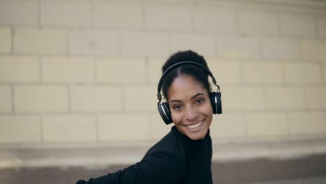 Happy-Woman-Wear-Wireless-Headphones-Listening-To-Music-Outdoors-On-An-Empty-Street-1
