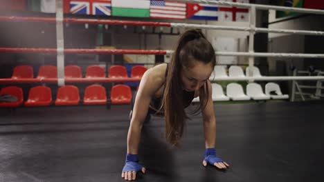 Female-Boxer-In-Boxing-Bandages-Doing-Push-Ups-While-Training-In-Boxing-Ring