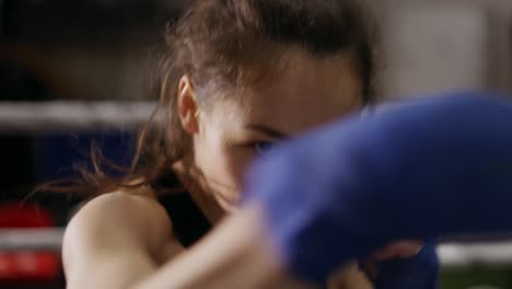 Female-Boxer-Performing-Active-Punching-In-Bandages,-Close-Up