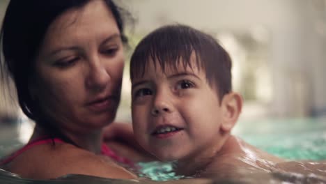 Smiling,-Brunette-Boy-Is-Swimming-In-The-Pool-Together-With-His-Mother