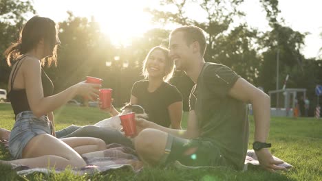 Portrait-Of-Three-Friends-Hanging-Out-Together-In-The-Park