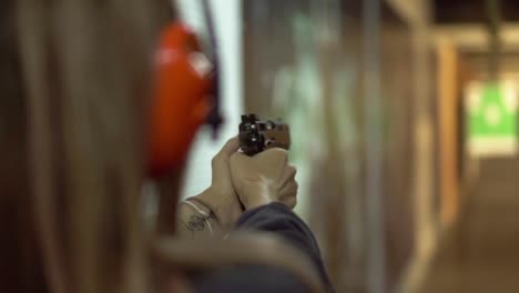 Woman's-Hands-Holding-Gun,-Targeting-In-Range-And-Making-Few-Shots