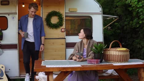Portrait-Of-Cheerful-Couple-Outdoors-Near-Their-Trailer-House