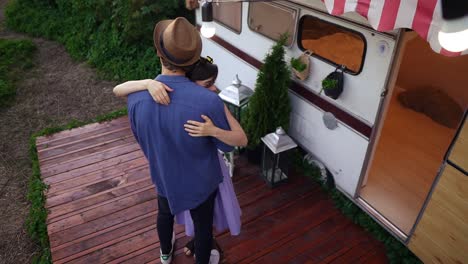 Young-Couple-Dancing-Slow-Dance-Embracing-In-Front-The-Trailer,-Wheels-House