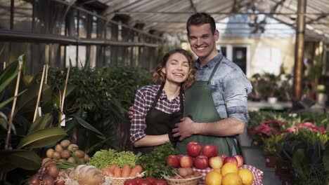 Portrait-Of-Beautiful-Farmers-Man-And-Woman-In-Aprons-Selling-Organic-Food-In-Farm-Market-1