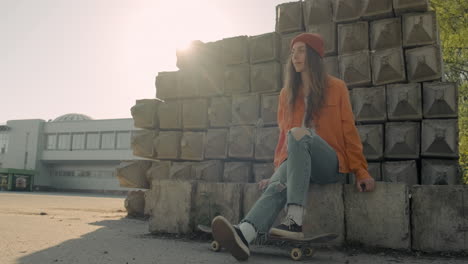 Skater-Girl-Waiting-For-Someone-Sitting-On-A-Cement-Block