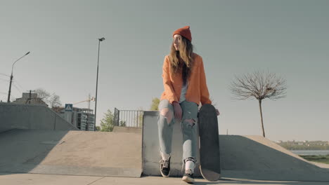 Skater-Girl-Waiting-For-Someone-Sitting-On-A-Skate-Park