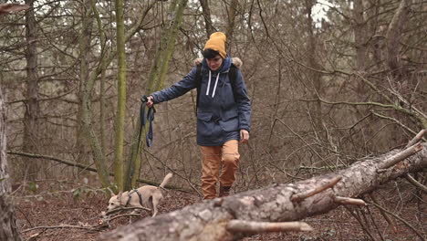 A-Young-Woman-With-Short-Hair-Takes-A-Walk-With-Her-Dog-Through-The-Forest
