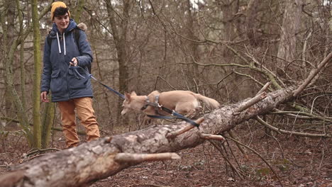 A-Young-Woman-With-Short-Hair-Takes-A-Walk-With-Her-Dog-In-The-Woods-2