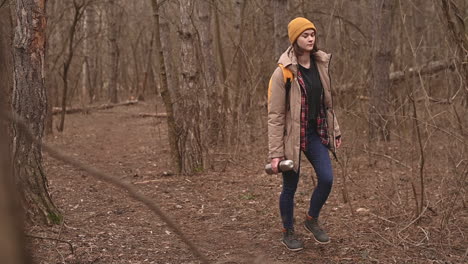 A-Young-Girl-In-A-Yellow-Woolen-Hat-Walks-Through-The-Forest