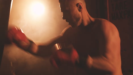 Shirtless-Boxer-Male-Warms-Up-By-Hitting-The-Punching-Bag-1