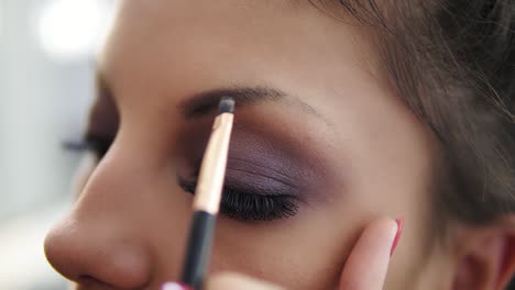 Closeup-View-Of-The-Makeup-Artist's-Hands-Correcting-Eyebrows-Using-Special-Brush