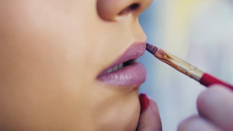 Closeup-View-Of-A-Professional-Makeup-Artist-Applying-Lipstick-On-Model's-Lips-Working-In-Beauty-Fashion-Industry