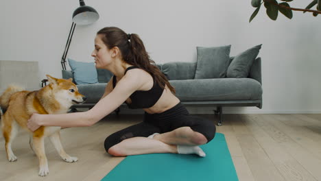 A-Girl-Takes-A-Break-From-Her-Yoga-Session-To-Play-With-Her-Cute-Dog-1