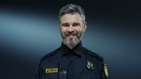Portrait-Shot-Of-The-Young-Good-Looking-And-Joyful-Policeman-With-Gray-Hair-Smiling-To-The-Camera