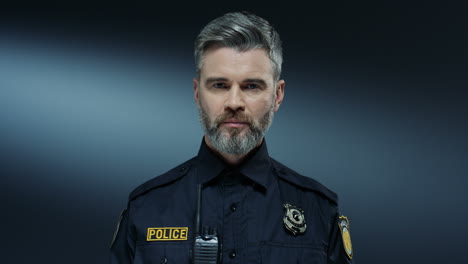 Portrait-Of-The-Handsome-Young-Policeman-In-The-Uniform-Looking-Straight-To-The-Camera-With-Serious-Face
