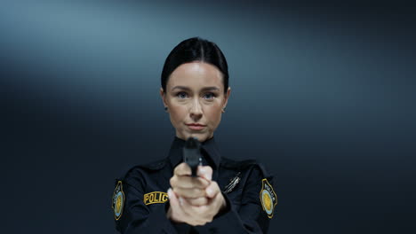 Portrait-Shot-Of-The-Young-Attractive-Policewoman-Turning-To-The-Camera-And-Pointing-A-Gun-At-The-Camera