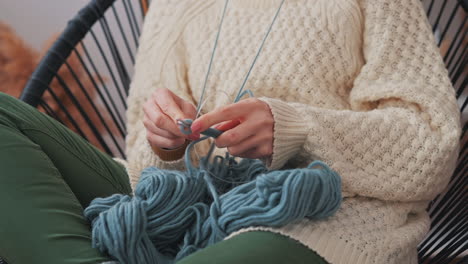 The-Hands-Of-An-Unrecognizable-Girl-Knitting-With-Blue-Wool