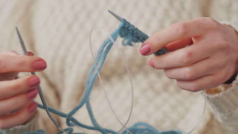 The-Hands-Of-An-Unrecognizable-Girl-Knitting-With-Blue-Wool-1