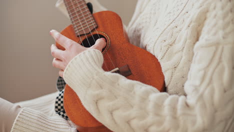 The-Hands-Of-An-Unrecognizable-Girl-Playing-The-Ukelele