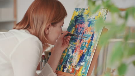 A-Red-Haired-Girl-Paints-A-Very-Colorful-Impressionist-Painting