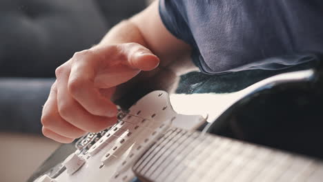 The-Hands-Of-An-Unrecognizable-Man-Playing-An-Electric-Guitar