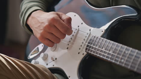 The-Hands-Of-An-Unrecognizable-Man-Learning-To-Play-The-Electric-Guitar