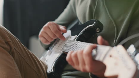 The-Hands-Of-An-Unrecognizable-Man-Learning-To-Play-The-Electric-Guitar-1