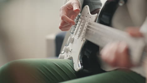 The-Hands-Of-An-Unrecognizable-Woman-Learning-To-Play-The-Electric-Guitar