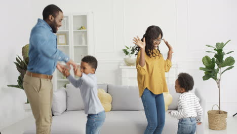 Happy-Joyful-Family-Dancing-And-Having-Fun-In-Living-Room-At-Home-During-Lockdown