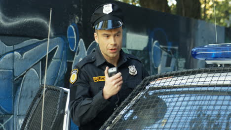 Anxious-Young-Policeman-In-Cap-Talking-In-Walkie-Talkie-And-Passing-Important-Information-To-Police-Office