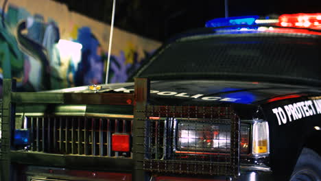 Close-Up-Of-The-Police-Car-With-Lights-From-The-Side-At-Night