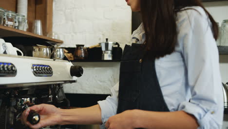 Portrait-Of-The-Beautiful-Young-Waitress-Making-Coffee-At-The-Special-Coffee-Machine-And-Smiling-To-The-Camera