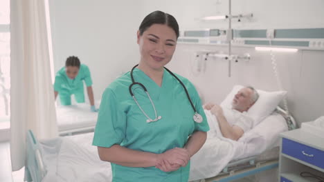 Woman-Nurse-Looks-Directly-Into-The-Camera-And-Smiles