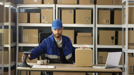 Young-Man-Taking-Carton-Parcel-From-Shelf-And-Bringing-To-Table