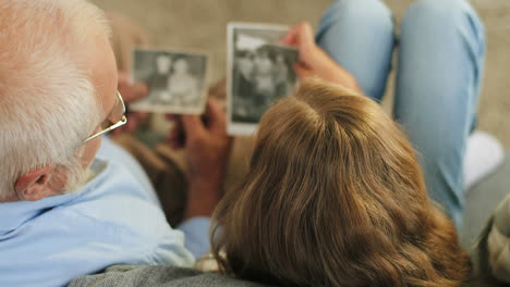 View-Over-The-Heads-On-The-Grandfather-And-Small-Granddaughter-Looking-At-The-Old-Photographs