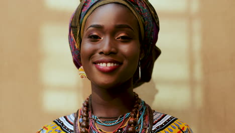 Close-Up-Of-The-Face-Of-The-Young-Charming-And-Happy-Woman-In-The-Scarf-On-Her-Head-And-Traditional-Look-Laughing-To-The-Camera