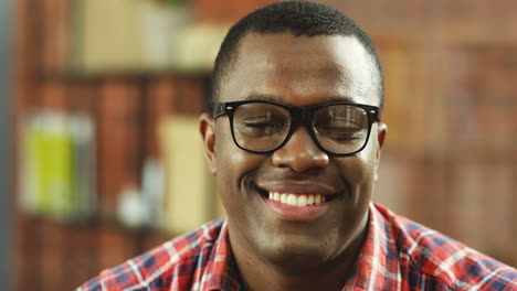 Portrait-Of-The-Cheerful-Man-In-Glasses-Smiling-To-The-Camera