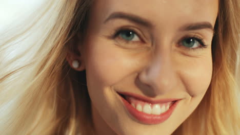 Close-Up-Of-The-Face-Of-The-Beautiful-Blonde-Young-Woman-Smiling-And-Looking-Straight-To-The-Camera