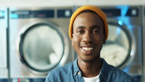 Close-Up-Of-Blurred-Cheerful-Young-Man-Smiling-To-Camera-In-Laundry-Service-Room
