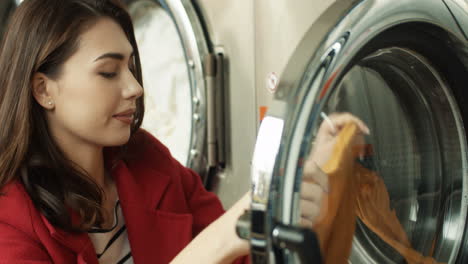 Close-Up-Of-Pretty-Woman-Taking-Out-Clean-Clothes-From-Washing-Machine