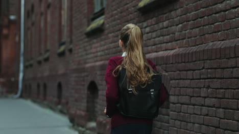 Back-View-On-The-Schoolgirl-In-The-Uniform-And-With-A-Bag-Walking-The-Street-After-Classes-At-School
