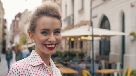 Portrait-Of-Young-Beautiful-Girl-With-Blonde-Hair-And-Retro-Style-Smiling-To-Camera-Cheerfully-At-Street