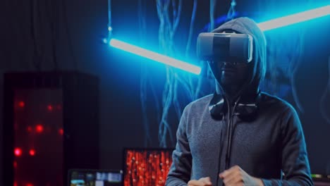 Anonymous-Man-In-Vr-Glasses-Having-Headset-And-Virtual-Reality-Tour,-While-Dancing-In-The-Dark-Room-With-Neon-Lamps-And-Wires