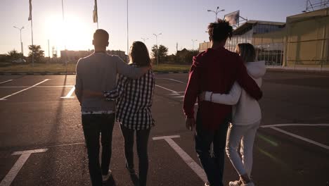 Group-Of-Young-Multirace-Couples-Laughing-While-Walking-By-Asphalt-Road